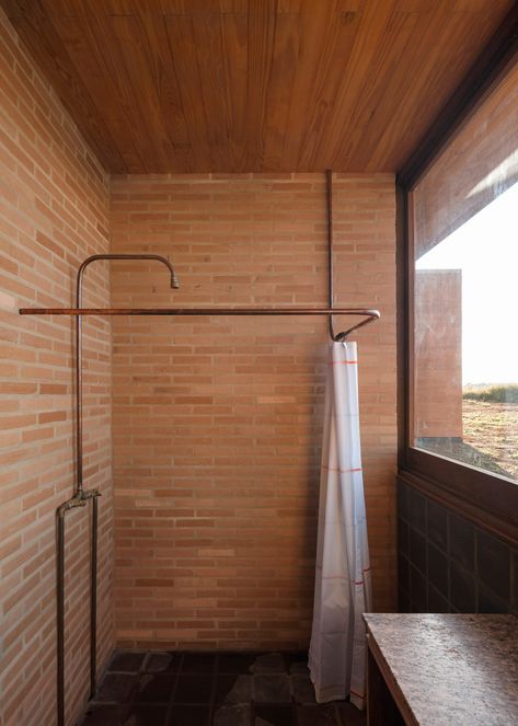 Arquipélago Arquitetos builds low-slung Brazilian house with rammed earth Dark Grey Tile, 1960s House, Peaceful Bedroom, Rammed Earth Wall, Wooden Bath, Tile Covers, Copper Tube, Rural House, Rammed Earth