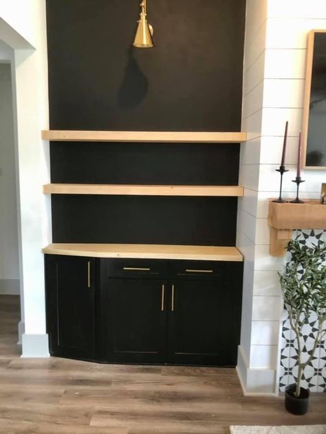 Floating Shelves Black Wall, Floating Shelves Cabinet, Floating Shelves On Black Wall, Black Accent Wall With Shelves, Black Accent Wall With Floating Shelves, Shelves On Black Wall, Floating Shelves Black Cabinets, Floating Shelves In Man Cave, Black Wall With Floating Shelves