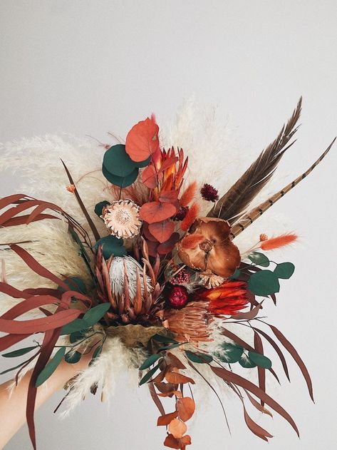 Bridal dried flower bouquet by KAYYA DECOR  embraced autumn orange wedding color with feathers and boho style arrangement but threw in some cream pampas grass and green preserved eucalyptus for good measure. This fall wedding bouquet perfect match for a boho wedding, rustic wedding, hippie wedding Cream Pampas, Burnt Orange Bridal Bouquet, Dried Flower Bridal Bouquet, Autumn Wedding Decor, Bouquet Fall Wedding, Orange Bridal Bouquet, Orange Wedding Colors, Preserved Eucalyptus, Bridal Bouquet Fall