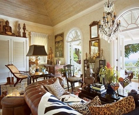 The master bedroom's sitting area faces the Caribbean. Among its plethora of furnishings and decorative objects are a chesterfield sofa, a circa 1900 Sri Lankan planter's chair, Buddhas from Burma and Thailand, santos from the Philippines and a side table by Servais. Caribbean Homes Interiors, British Colonial Interiors, Cottages Interiors, Exotic Bedrooms, Balinese Interior, Cottage Interior Design, British Colonial Decor, English Cottage Decor, Caribbean Homes