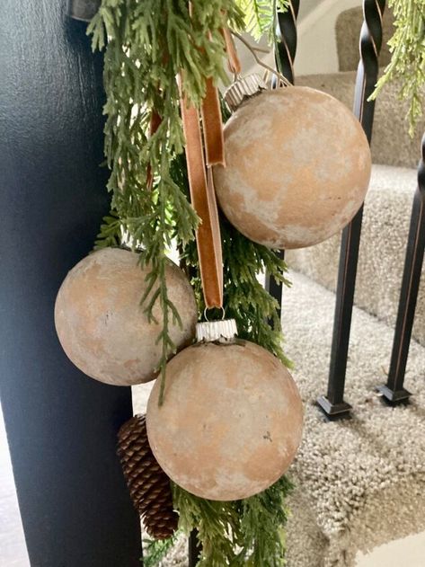 I’ve seen many ways to do this, but here’s my take on it. You can definitely buy them, but it’s a fun project to do with the kids or by yourself. I love how they turned out! Here’s what you’ll need.clear glass or plastic balls (dollar Tree, Amazon)cream paint, brown paint (Dollar Tree)gold paint , bronze paint (Dollar Tree)velvet Ribbon (Temu)baking soda (Walmart) Start by painting the ball. Before the paint dries, sprinkle some baking soda over it, then set aside to dry. Once… Glass Christmas Balls Ideas, Diy Baking Soda Ornaments, Spray Painted Ornaments, Christmas Plastic Ornaments Diy, Walmart Christmas Ornaments, Decorating Glass Ornaments, Dollar Tree Crafts Diy Christmas Ornaments, Diy Paint Ornaments Christmas, Diy Painted Christmas Balls