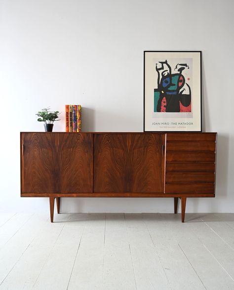 Discover the elegance and functionality of this original 1960s Danish rosewood sideboard, a quintessential piece that captures the essence of Nordic modernism. Crafted with meticulous attention to detail, this sideboard blends style, functionality, and impeccable craftsmanship. Dimensions (in cm): Width: 225cm/88.58inch Height: 105cm/41.33inch Depth: 47cm/18.50inch The refined structure features two sliding doors on one side and six drawers with hidden handles on the other. This versatile design Midcentury Sideboard Living Room, Mid Century Side Board, Sideboard Bedroom, Sideboard Living Room, Mid Century Modern Storage, Mid Century Modern Sideboard, Mid Century Cabinet, Retro Sideboard, Sideboards Living Room