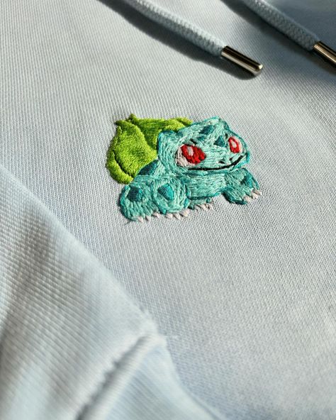 Raise your hand if you’re part of the Pokemon tribe 🩵🥹 . . . #customembroiderydesigns #customized #customembroidery #customisation #art #artist #artistoninstagram #customisedgifts #giftsforher #giftideas #giftsforhim #sweatshirtcustomisation #tshirtcustomisation #chennaibasedembroidery #chennaiembroidery #chennaibased #artbychahat Embroidery Pokemon, Pokemon Embroidery, Pikachu Embroidery Pattern, Pokeball Embroidery, Pokemon Embroidery Pattern, Bulbasaur Embroidery, Embroidered Pokemon, Bulbasaur Cross Stitch, Pokemon Embroidery Hoodie