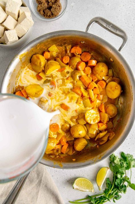 Skip the takeout, and make this Thai vegan yellow curry with potatoes, carrots, onions, and tofu. This is a one-pot meal that is perfect for those hectic weeknights. The recipe comes together in under an hour and is loaded with vegetables, and can be served over rice. Finish this dish off with some fresh lime juice and cilantro, and you have yourself a yummy meal. The whole family will love this cozy, hearty dinner, especially during winter! Yellow Curry Potatoes, Vegan Yellow Curry, Curry With Potatoes, Thai Vegan, Carrot Curry, Yellow Curry Paste, Yellow Curry, Yellow Potatoes, Potatoes Carrots