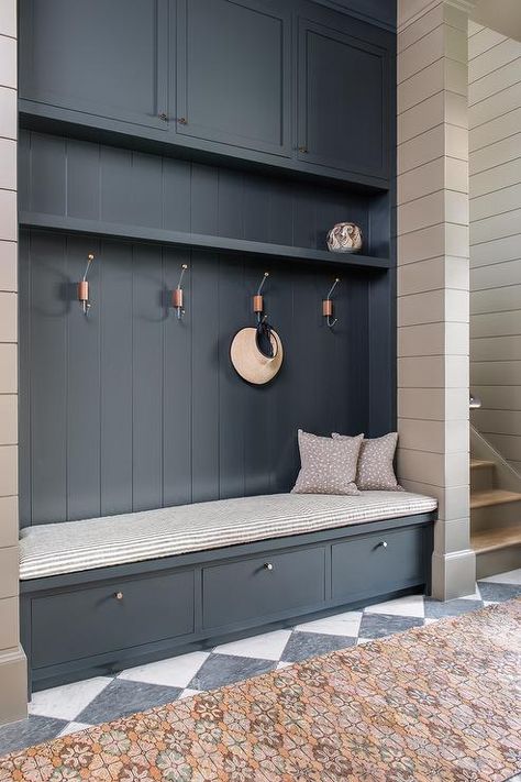 Blue mudroom bench on a gray and black checkered floor in a transitional foyer. Blue Mudroom, Contemporary Hamptons, Drop Station, Cortney Bishop, Drop Zones, Transitional Laundry Room, Mudroom Cabinets, Calming Interiors, Mud Room Entry