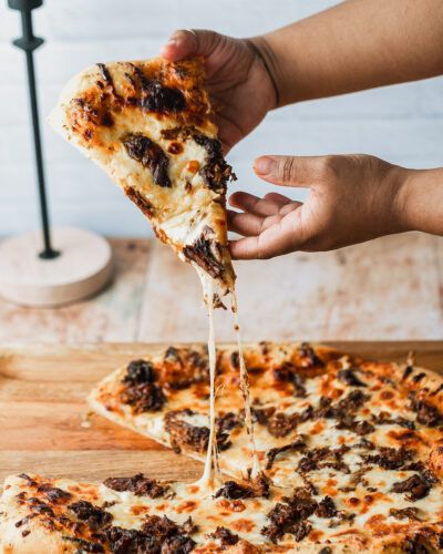 Looking for a delicious way to use your leftover birria de res? Make super cheesy birria pizza! Using my classic chewy pizza crust recipe brushed with melted garlic butter, it's topped with juicy beef birria, super flavorful consommé, and tons of oaxaca cheese. This is a family friday movie night favorite at our house! Continue reading Birria Pizza at Sweet Tea + Thyme. Leftover Birria, Chewy Pizza Crust, Birria Pizza, Birria Recipe, Weekday Recipes, Homemade Honey Butter, Beef Birria, Honey Butter Chicken, Homemade Buttermilk Biscuits