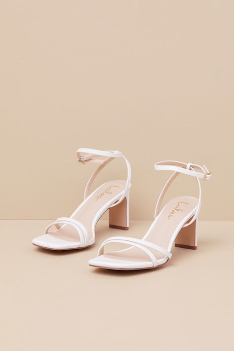 Any luxe look deserves a fabulous finish, which is why you'll always reach for the Lulus Loxley White Ankle Strap High Heel Sandals to complete the 'fit! Smooth faux leather shapes these too-chic heels that feature a square toe bed, slender asymmetrical toe straps, and matching straps that sprout from the sides to wrap and secure around the ankle with a gold buckle. A stylish blade heel adds an extra-trendy touch to this sleek design! 2. 75" wrapped blade heel. Cushioned insole. Rubber sole has Cute White Heels Lulus, White Heels With Single Toe Strap For Summer, White Low Heels, White Prom Heels, Feminine White Ankle Strap Heels, Heels White, White High Heel T-strap Sandals, Modern White Sandals With 4-inch Heel, White Shoes Heels