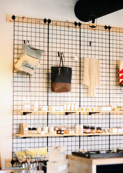 Daytrippin’ | City + State Coffee Shop Coffee Shop Retail Design, Grab And Go Store Design, Kallax Retail Display, Grid Wall Retail Display, Coffee Shop And Clothing Store, Coffee Shop Merch Display, Coffee Shop Storage, Industrial Coffee Shop Design, Cafe Shelf