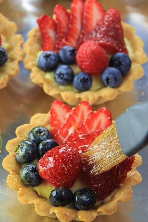 Fresh berries and an apricot jam glaze make this Mini Fruit Tart Recipe stand out in a crowd on your dessert buffet. Mini Fruit Tart Recipe, Fruit Tart Glaze, Mini Fruit Tart, Fruit Custard Tart, Fruit Tart Recipe Mini, Fruit Tart Recipe Easy, Fruit Tart Filling, Berry Tarts, Mini Tart Recipes