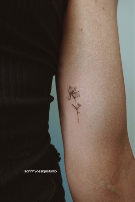 Inner Bicep Fine Line Tattoo, Delicate Iris Tattoo, Flower Tattoos Iris, Microrealism Tattoo Flower, Tiny Flower Hand Tattoo, Iris Hip Tattoo, Flower Iris Tattoo, Small Fine Art Tattoo, Bicep Fine Line Tattoo