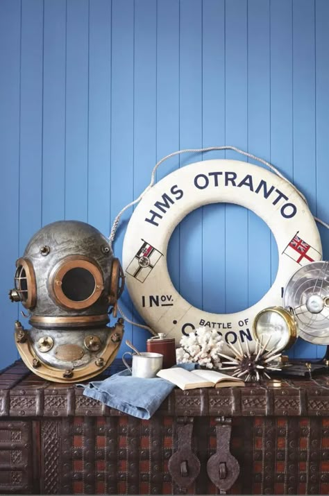 A collection of nautical themed decorations including an antique diver's helmet Dream Apartments, Nautical Antiques, Nautical Bar, Seaside Cafe, Vintage Nautical Decor, Nautical Aesthetic, Porthole Mirror, Nautical Room, Nordic House