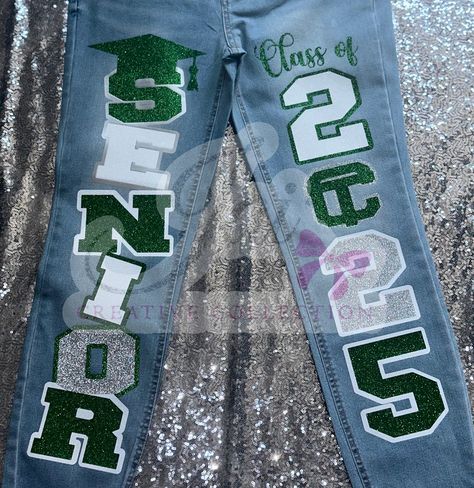 CUSTOM JEANS 💚🩶🤍 customized by @jaicreativecollection 🎀 —————————— DM or TEXT (313)318-0114 to place an order📲 ✨ —————————— (JEANS👖 PROVIDED BY CUSTOMER! CUSTOMIZATION FEE $65!) —————————— #senior2025 #2025 #seniorszn #classof2025 #jaicreativecollection🎀 #seniorsets #customseniorjeans #seniorjeans #detroitsmallbusiness #trojans #customizedjeans ##seniorskirt #customseniorjeans #panthers Senior Jeans Ideas, Hoco Jeans, Senior Painted Jeans, Senior Pants, Senior Year Fun, Senior Jeans, Senior Szn, Senior Stuff, Senior Overalls