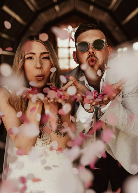 The bride and groom blowing pink, white and red confetti at their wedding in Wales Wedding Photos Funny Creative, Wedding Idea Photoshoot, Cheesy Wedding Photos, Wedding Photos Confetti, Unique Couple Wedding Photos, Fun Wedding Photography Ideas, Funky Wedding Photos, Wedding Photos In A Bar, Disco Wedding Photos