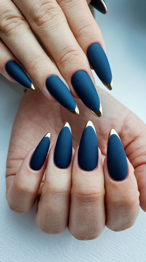 Elevate your nail game with this chic matte navy design featuring elegant gold tips! The sharp, elongated shape adds a touch of sophistication, perfect for any occasion. Ideal for those who love bold and stylish nail art, this look combines modern elegance with a hint of glamour. Try it for your next night out or special event! #NailArt #MatteNails #NailDesignInspiration #fallnails #septembernails Wedding Nails For Navy Blue Dress, Matte Navy And Gold Nails, Classy Navy Nails, Nail Art Designs Navy Blue, October Vacation Nails, Navy And Gold French Tip Nails, Navy Autumn Nails, Blue Beige Nails, Red And Navy Nails