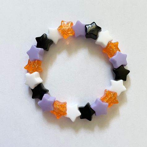 This bracelet is made of adorable star beads in Halloween colors! Made to fit up to a 7 inch wrist. If you have any questions please message me! Star-shaped Beaded Party Bracelets, Cute Multicolor Star-shaped Beaded Bracelets, White Star-shaped Bracelet With Colorful Beads, White Star Bracelets For Party, White Star-shaped Party Bracelets, Halloween Kandi Ideas, Halloween Kandi Bracelets, Kandi Halloween, Halloween Bracelet Ideas