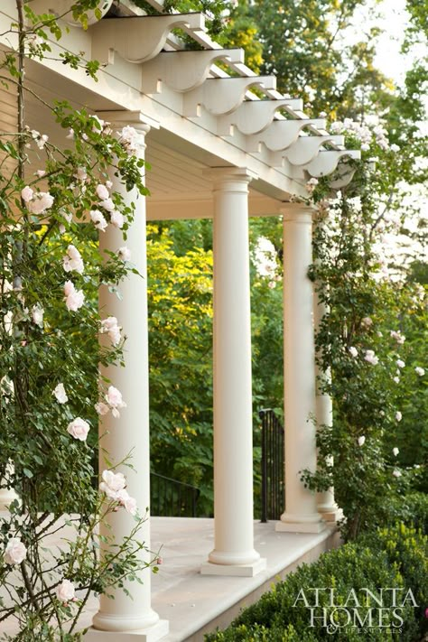 Roses climb a covered gazebo area off the guest house. opposite Graceful original details of the Neel Reid English Regency style home include a metal awning and a palladian window above. Rambling Roses, Atlanta Homes And Lifestyles, Garden Vines, Wooden Pergola, Atlanta Homes, Porch Garden, Diy Pergola, Pergola Designs, Climbing Roses