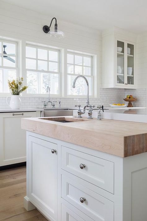 A butcher block prep island sits at the end of a larger kitchen island and is fitted with satin nickel hardware and a prep sink with a polished nickel deck mount faucet. Cottage Style Kitchen, Prep Sink, Large Kitchen Island, Ideas Hogar, White Kitchen Cabinets, Trendy Kitchen, Farmhouse Sink, Cottage Kitchen, Large Kitchen