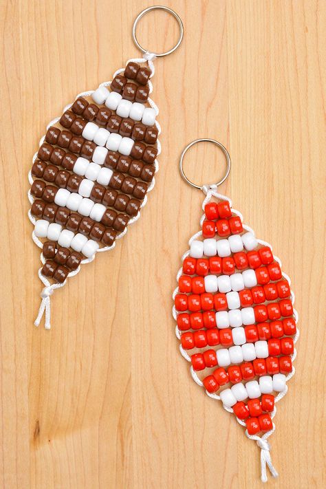 Celebrate the Super Bowl with this pony bead football! Make a football keychain in your favourite team's colours - it's SO EASY! You only need a few simple supplies to make this sports craft for kids of all ages, and it looks so fun hanging on a bag or backpack. This is such a fun Super Bowl craft and a great craft for boys and girls. Football Beaded Keychain, Cute Pony Bead Patterns, Fall Pony Bead Crafts, Mario Pony Bead Patterns, Football Keychain Diy, Easy Pony Bead Crafts, Christmas Pony Bead Crafts, Pony Bead Animals Patterns Easy, Pony Bead Crafts Keychains