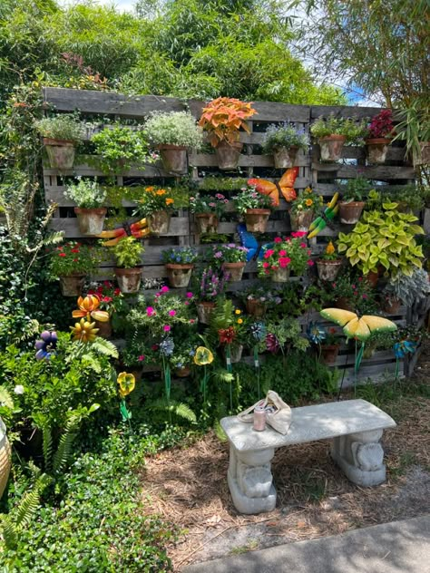 outside sitting area with butterfly statues and potted plants as the backdrop. Hidden Sitting Area Garden, Arbor Sitting Area, Garden Sitting Area Ideas Diy, Garden Hangout Area, Pretty Garden Ideas Backyards, Creative Yard Ideas, Diy Outdoor Sitting Area, Outdoor Corner Ideas, Outside Reading Area