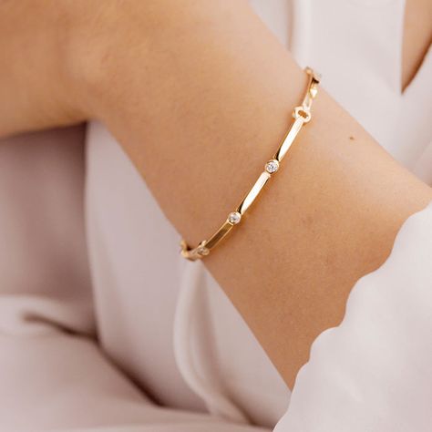 The Copley Multi Stone Bangle is delicate and fun, but boasts a big sparkle . The diamonds are delicately placed throughout the bangle, and this thinner design is a classic style to bring you from day to night. This bracelet can be worn alone or stacked with others for a bold effect. This bangle comes in either 18K Yellow Gold, or 18K White Gold. Rose gold available as a special order. It holds approximately .16 carats total weight of diamonds. Size medium. Delicate Diamond Bracelet, Gold And Diamond Bracelet, Hearts On Fire, Diamond Bracelet Design, Diamond Fashion Jewelry, Simple Diamonds, Diamond Bangles Bracelet, Jewelry Appraisal, Stone Bangle