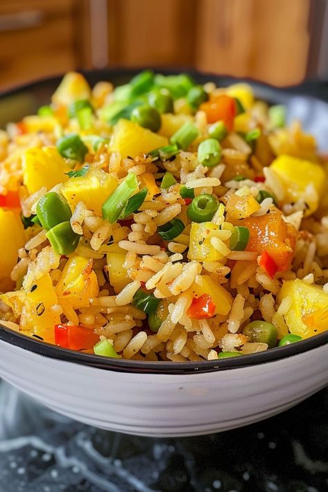 Pineapple Fried Rice is a delicious and nutritious choice for any mealtime! 🍍🍚 Made with tender rice, juicy pineapple, and a medley of fresh vegetables, this dish is a delightful blend of sweet and savory flavors. Quick to prepare and bursting with tropical goodness, Pineapple Fried Rice is perfect for a refreshing lunch or satisfying dinner. Indulge in this vibrant twist on a classic favorite today! 😋🌿 #PineappleFriedRice #TropicalFlavors #HealthyEating #DeliciousMeals Yellow Fried Rice, Tropical Rice, Chicken And Pineapple, Fries Chicken, Pineapple Salad, Pineapple Fried Rice, Yummy Dishes, Savory Foods, Deep Dish Pizza