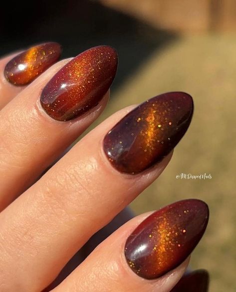 Pull out all the stops with these special effects gel polishes! ⭐️ is The Cat's Meow! 🐈️🧲🌡️ These babies have a temp changing pigment in the base + magnetic cats eye shimmer for infinitely stunning looks!🧡⁠ Shop here and get 65% of a gel starter kit: https://www.peppigel.com/dipdelights ⁠ -⁠ #ChristmasNails #peppigel #dippowder #dippowdermanicure #dippowdernails #dip #glitter #diy #nails #glitternails #diy #dipnails #nailart #mani #inspo #sparkle #sparklynails #sparkly #gel #dipgel #geldip #... Magnetic Dip Nails, November Nails Cat Eye, Orange Glitter Gel Nails, October Cat Eye Nails, Orange Magnetic Nails, Tigers Eye Nails Polish, Thanksgiving Nails Cat Eye, Fall Festive Nails, Autumn Nails Cat Eye