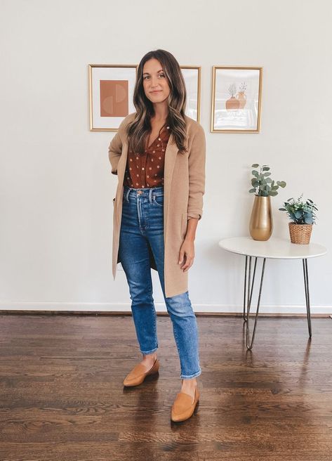 ashley wearing a patterned rust colored peasant blouse, medium wash jeans, and cognac loafers; in the background a white side table with 2 faux plants and 3 prints in gold frames Joanna Gaines Outfits Fall, Office Outfits Fall 2023, Madewell Winter Outfits, Plus Size Casual Professional Outfit, Layering Women Outfit, Fall Photoshoot Women Outfit, Teacher Winter Capsule Wardrobe, Fall Style For Women In Their 30s, Easy Fall Outfits For Work