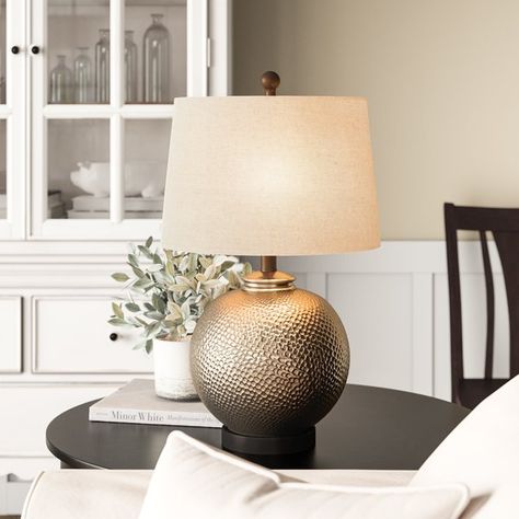 Lightweight, portable, and mindful of space, table lamps keep your home looking on the bright side with just-right task and accent lighting. This design, crafted from metal, showcases a hammered texture across its orb-shaped body for dimensional appeal, while a gray linen empire shade sports a speckled pattern for extra visual intrigue. Measuring 24'' H x 14'' W x 14'' D, it’s a perfectly posh pic for punctuating an end table. Front Door Table, Neutral Lamps, Brown Table Lamp, Bedroom Revamp, Door Table, Classic Table Lamp, Brown Table, Stylish Tables, Table Lamp Base