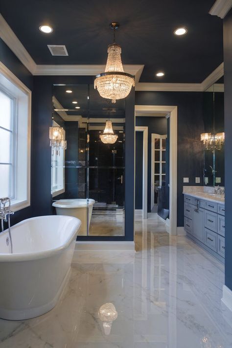 A luxurious blue bathroom featuring deep, dark blue walls with crystal chandeliers and elegant gold accents for a dramatic atmosphere. Bathroom Remodel Blue, Royal Blue Bathroom, Blue Bathroom Decor Ideas, Royal Blue Bathrooms, Blue Decor Ideas, Dark Blue Bathroom, Historic Bathroom, Blue Bathrooms, Dark Blue Bathrooms