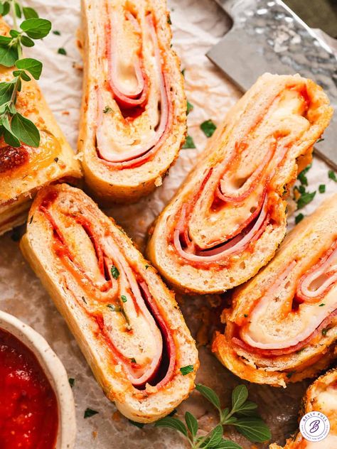 Ham, pepperoni, salami, and cheese are rolled up in refrigerated pizza dough in this Easy Stromboli recipe. It's saucy, cheesy, and super easy to make. Feel free to customize it with your favorite toppings! Pepperoni And Cheese Stromboli, Ham And Cheese Stromboli, Stromboli Pizza, Cheese Stromboli, Easy Stromboli, Stromboli Recipe Easy, Homemade Stromboli, Refrigerated Pizza Dough, Salami And Cheese