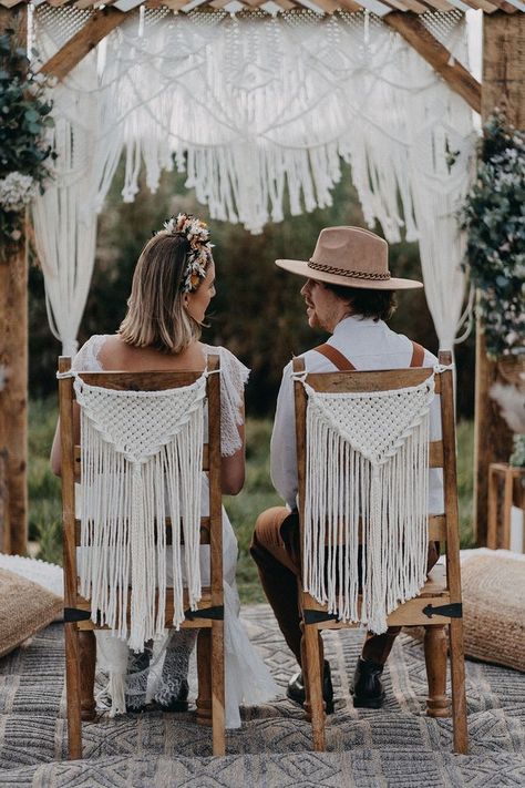 Handmade macrame chair back decor with the bride and groom seated for their outdoor wedding ceremony Macrame Chair Back, Dried Flower Headband, Wedding Chairs Diy, Macrame Chair, Outdoorsy Wedding, Wedding Chair Sashes, Wedding Archway, Wedding Chair Decorations, Boho Chair