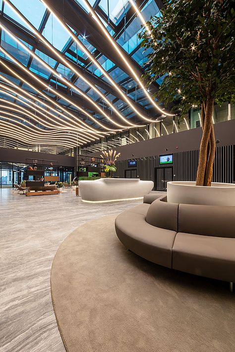 Gallery of Coverlam Medusa in Hillside Office Building - 3 Office Building Reception Lobby, Modern Atrium Design, Entertainment Building Design, Atrium Lighting, Building Lobby Design, Building Entrance Lobby, Lobby Ceiling Design, Building Entrance Design, Mall Architecture