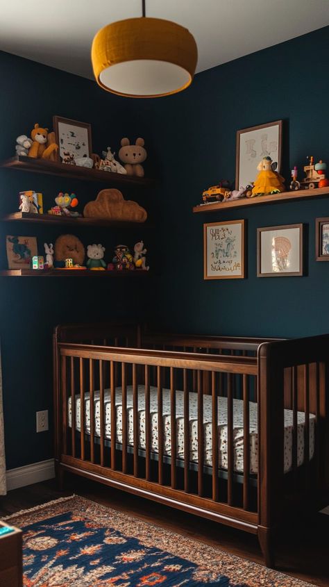 Cozy gender-neutral nursery with dark blue walls, vintage crib, wooden shelves, soft lighting, and whimsical decor. Moody Woodland Nursery, Deep Blue Nursery, Dark Blue Nursery Boy, Dark Teal Nursery, Dark Wood Crib Nursery, Navy Baby Room, Colorful Boy Nursery, Dark Blue Nursery, Midcentury Nursery