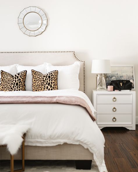 My bedroom is the ultimate single girls oasis 💕 I wanted it to be light and airy with a subtle touch of pink! What you can't see is my closet... Truthfully, there isn't room in the closet for a man right now! // Screenshot or Leopard Pillows On Bed, Neutral Cheetah Bedroom, Leopard Pillow Bedroom, White And Leopard Bedroom, Cheetah Dorm Room Ideas, Pink And Leopard Bedroom, Leopard Bedroom Decor, Gorgeous Bedrooms, White Leopard