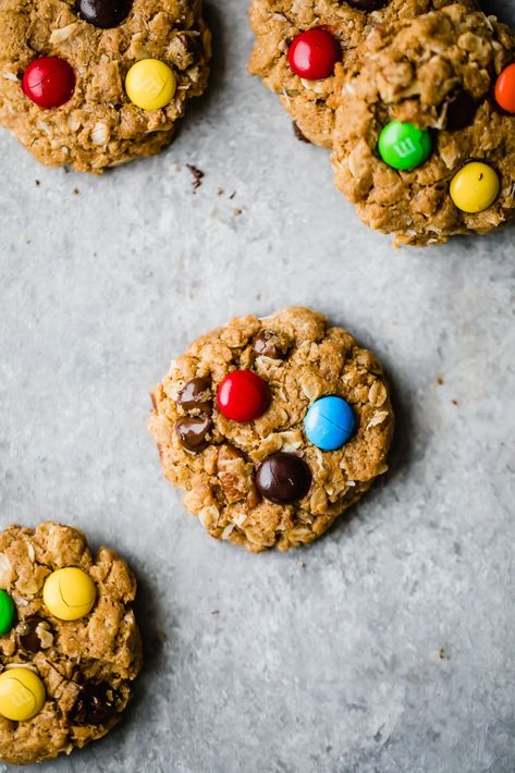 Incredible healthy monster cookies packed with peanut butter flavor, chocolate chips, coconut, chocolate candy pieces and nuts. These flourless monster cookies are a wholesome take on a childhood classic you know and love! Easy to make and great for customizing. #cookies #monstercookies #oatmealcookies #glutenfree #flourless #healthybaking #healthydessert Monster Cookies Recipe, Monster Cookie, Ambitious Kitchen, Chunky Peanut Butter, Healthier Desserts, Ginger Molasses Cookies, Coconut Chocolate, Gluten Free Chocolate Chip, Healthy Cookie Recipes