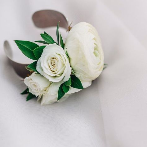 Floral bracelets are my fav. This one features white ranunculus and spray roses set on a nickel cuff. . . Photo by  the lovely… White Ranunculus Boutonniere, White Corsage, Ranunculus Boutonniere, Wrist Corsage Wedding, White Spray Roses, Floral Cuff, Rose Corsage, Chelsea Wedding, Hypericum Berries