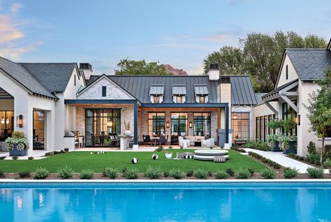 “I think the way we used the reclaimed brick, basalt stone details, and metal and slate roofs really speaks to the artisan-crafted home,” says architect Matthew Thomas of an Arcadia home. “It’s about creating a story.” Modern Traditional Home Exterior, Industrial Farmhouse Decor, Steel Doors And Windows, Transitional Farmhouse, Basalt Stone, Reclaimed Brick, Farmhouse Decor Ideas, Modern Ranch, Modern Farmhouse Exterior