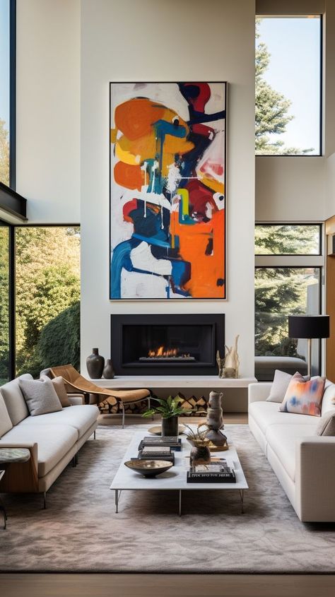 Modern living room with colorful abstract painting above fireplace, natural light, neutral-toned furnishings. Ideal setting for relaxation and entertainment. Above Fireplace Ideas Modern, Fireplace Double Height, Art For Tall Walls High Ceilings, Modern Fireplace Decor, Above Fireplace Ideas, Ceiling Artwork, Terrace Extension, Sleek Fireplace, Modern Living Room Design