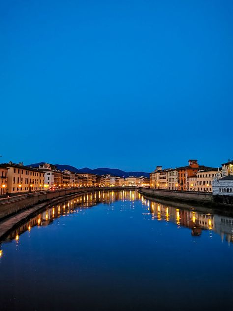 Nightfall in Pisa: Where the Arno becomes a river of lights, painting the city with shimmering reflections. Arno River Florence Italy, River Reflection, Lights Painting, Bridge Over River, River Seine, Arno River, Paris Seine River, Pisa, The City