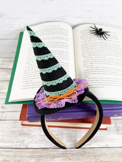 Create a No-Sew Witch Hat Headband with Fabri-Fuse and Kunin Classic Felt.  This mini witch's hat is perfect when perched on top of a headband for the biggest or littlest witch in all of us. Or it can be left solo to create a super cute and spooky piece of home decor for your tiered tray. The best part is it can be totally customized with your favorite color of Kunin Classic Felt and some fun cotton trims. No Sew Felt Witch Hat Halloween Costume This post, No Sew DIY Witch Hat He… Sew Witch Hat, Diy Witch Hat, Witch Hat Headband, Unicorn Spit Stain, Felt Witch, Hat Halloween Costume, Felt Witch Hat, Cute And Spooky, Hat Headband