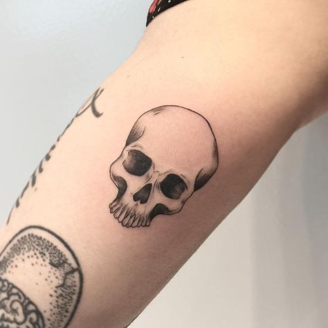 Skull tattoos are an extremely popular form of symbolism seen in both culture and tattoos. Let's explore the most common skull tattoos and their meanings. Skull Tattoos Small Simple, Micro Skull Tattoo, Skull Tattoo Patchwork, Simple Skull Tattoos For Women, Simple Realism Tattoo, Skull Tattoo Placement, Small Skull Tattoo For Women, Skull Tattoos Simple, Minimalist Skull Tattoo