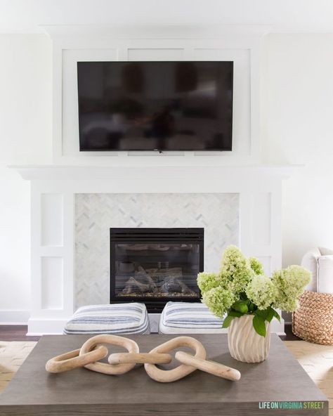 A shaker style fireplace mantle with board and batten and herringbone marble surround. Perfect in this coastal inspired living room! #home #homedecorideas #homedecor #livingroomdecor #livingroom #homeimprovement #fireplace Fireplace Mantel Decor With Tv, Shaker Style Fireplace, Style Fireplace Mantle, Tv Over Fireplace, Style Fireplace, Fireplace Update, Living Room Transformation, Driven By Decor, Small Family Room