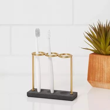 12 Modern Toothbrush Holders | Hunker Toothbrush Holder Ideas, Concrete Bathroom, Wrought Iron Candle, Bathroom Storage Solutions, Toothpaste Holder, Iron Candle Holder, Bathroom Toothbrush Holder, Century Decor, Bathroom Storage Organization