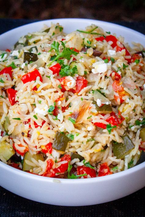 This one-pot Mediterranean rice recipe - packed with vegetables, tangy feta cheese, lemon zest, briny olives, and fresh parsley - captures the essence of Mediterranean flavors. Two sides in one! Rice With Feta Cheese, Mediterranean Rice Recipe, Olive Rice, Mediterranean Rice, Recipe With Vegetables, Mediterranean Flavors, Rice Side, Vegetable Rice, Baked Vegetables