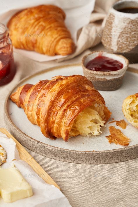 Two delicious croissants on plate and hot drink in mug, side view, vertical by Natabuena. Two delicious croissants on plate and hot drink in mug. Morning French breakfast with fresh pastries and jam. Light g... #Sponsored #mug, #drink, #view, #side Croissant With Jam, Croissant Photography, Morning Pastries, Breakfast Croissant, Fresh Pastries, French Croissant, Fruit Pastries, Croissant Breakfast, French Breakfast