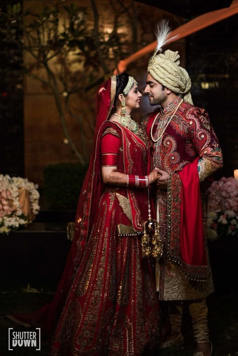 Photo of Traditional bride and groom in maroon outfits Couple Pose Wedding, Wedding Couple Pose, Marriage Poses, Bride Groom Photoshoot, Daaru Party Pic, Couple Wedding Photography, Wedding Photography Bridal Party, Bride Groom Poses, Indian Bride Photography