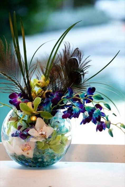 LOVE LOVE LOVE. Do not forget about this idea. I want these somewhere. Different coloured flowers though. Succulents as well? Peacock Art Deco Wedding, Peacock Feather Flower Arrangements, Peacock Theme Party, Peacock Wedding Centerpieces, Peacock Wedding Bouquet, Peacock Wedding Decorations, Peacock Centerpieces, Peacock Party, Peacock Wedding Theme