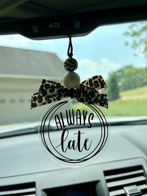 This adorable "always late" leopard print car charm/rearview mirror charm is the perfect vehicle accessory!!  Product comes with the following: black durable nylon - standard 25" from end to end  1 wood bead 1 silicone bead 3" acrylic disc leopard print bow black vinyl lettering *nylon cord is adjustable to suit your personal preference by tying knot at the desired length.   *this is a single sided car charm CAUTION:  Many items in this shop contain small parts and potentially present a choking hazard.  Please never allow children unattended while using these products.  All of my products should be used with adult supervision.  The buyer assumes all responsibility for its use. I take pride in my work & stand behind my products 100%.  If there is something you are not happy with, please mes Mirror Hangers For Cars, Rearview Mirror Decal, Acrylic Car Charms, Xtool Projects, Engraver Ideas, Personalized Car Tags, Car Mirror Decorations, Acrylic Crafts, Car Hanging Accessories