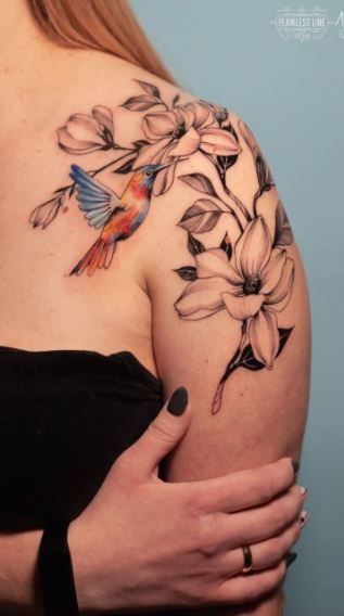 Tattoo With Hummingbird And Flower, Humming Bird Tattoo Back Shoulder, Tattoo Hummingbird Flower, Hummingbird Upper Arm Tattoo, Big Hummingbird Tattoo, Hummingbird Tattoo Sleeve Ideas, Humming Bird Tattoo Shoulder, Hummingbird Floral Tattoo Design, Hummingbird Magnolia Tattoo