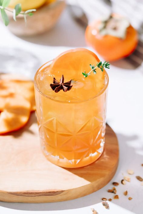 Spiced persimmon mocktail garnished with a persimmon slice, thyme and star anise. Persimmon Cocktail Recipes, Fall Party Drink Ideas, Persimmon Cocktail, Fall Party Drinks, Holiday Mocktail, Easy Mocktails, Holiday Recipies, Persimmon Recipes, Easy Mocktail Recipes